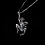 jane goodall sterling silver chimpanzee necklace holding a monkey wrench angled close up